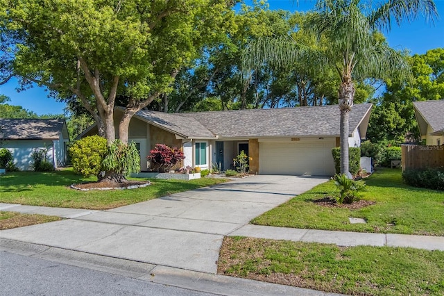 view of front of house with a garage, a front yard, stucco siding, and concrete driveway