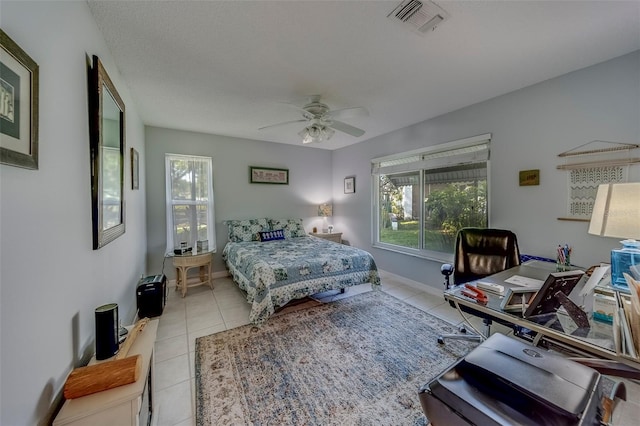 bedroom with tile patterned flooring, a desk, and a ceiling fan