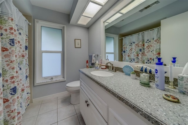 bathroom with tile patterned floors, toilet, vanity, and baseboards