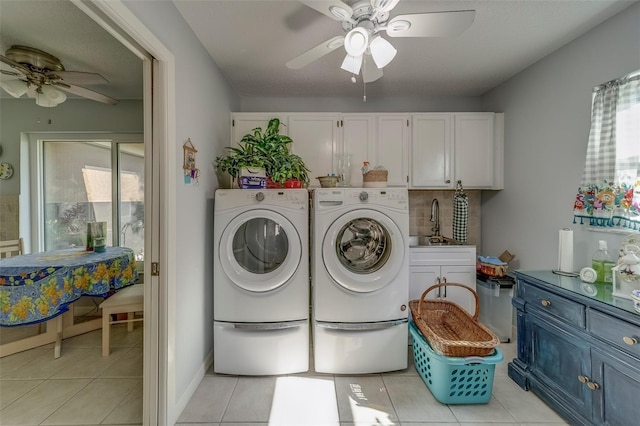 laundry area featuring a ceiling fan, washing machine and clothes dryer, cabinet space, and light tile patterned floors