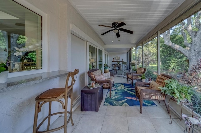sunroom featuring outdoor lounge area, a ceiling fan, and healthy amount of natural light