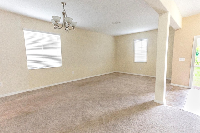 621 Washita Stone Dr, Ruskin, FL 33570 - empty room featuring carpet, baseboards, and a notable chandelier