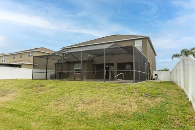 621 Washita Stone Dr, Ruskin, FL 33570 - rear view of house with a lanai, a lawn, and a fenced backyard