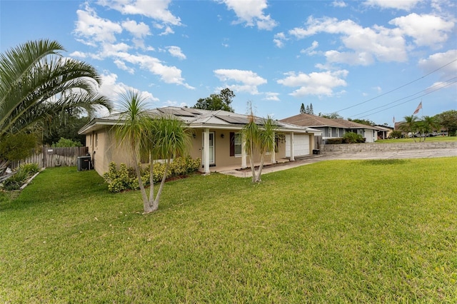 single story home with fence, an attached garage, concrete driveway, stucco siding, and roof mounted solar panels