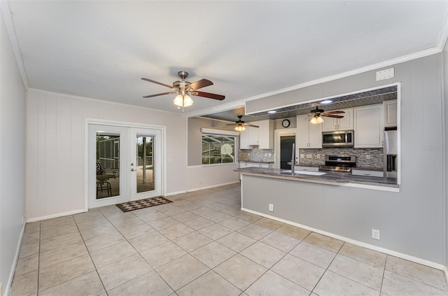 kitchen featuring a peninsula, crown molding, and stainless steel appliances