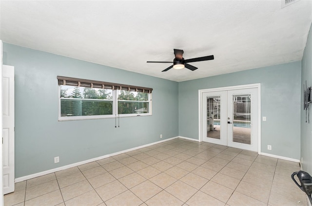 empty room featuring light tile patterned floors, baseboards, french doors, and a ceiling fan
