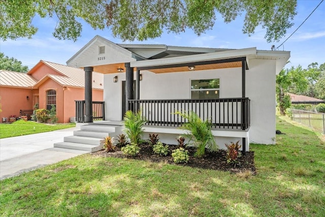 3215 E Powhatan Ave, Tampa, FL 33610 - view of front of home featuring a porch, a standing seam roof, metal roof, and stucco siding