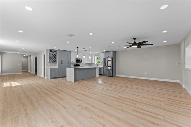 3215 E Powhatan Ave, Tampa, FL 33610 - unfurnished living room featuring light wood-style flooring, baseboards, recessed lighting, and ceiling fan