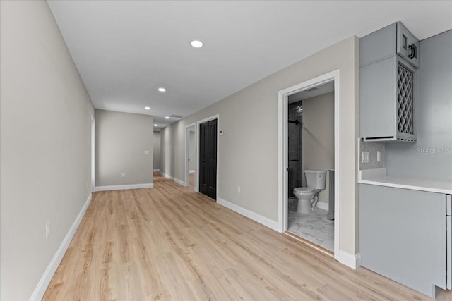 3215 E Powhatan Ave, Tampa, FL 33610 - unfurnished living room featuring light wood-type flooring, recessed lighting, and baseboards
