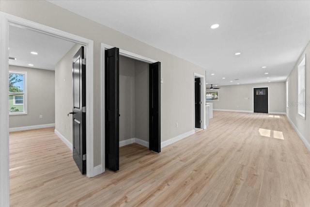 3215 E Powhatan Ave, Tampa, FL 33610 - unfurnished living room featuring light wood-style floors, baseboards, and recessed lighting