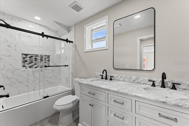 3215 E Powhatan Ave, Tampa, FL 33610 - bathroom featuring double vanity, bath / shower combo with glass door, toilet, and recessed lighting