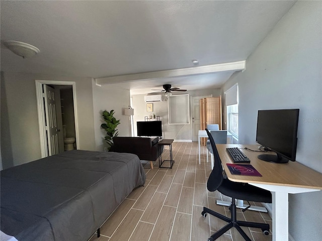 bedroom featuring wood finished floors and a wall unit AC