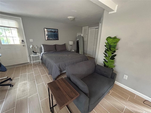 bedroom featuring baseboards, a closet, and wood tiled floor