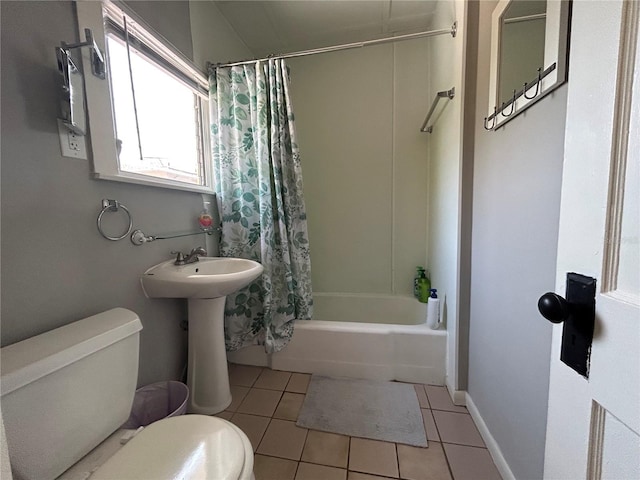bathroom featuring toilet, tile patterned floors, and shower / tub combo