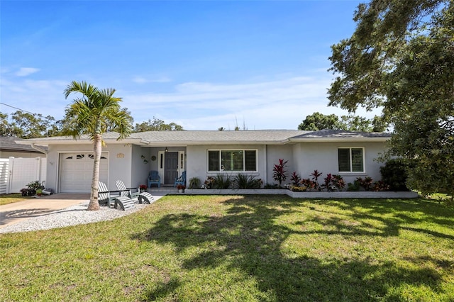 ranch-style home featuring stucco siding, a garage, driveway, and a front lawn