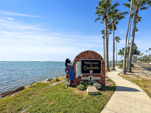 community / neighborhood sign with a water view