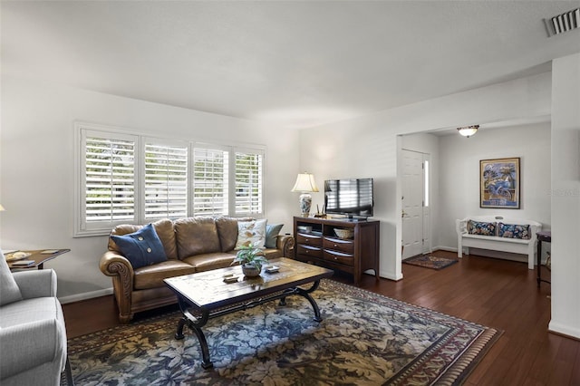 living area featuring hardwood / wood-style flooring and baseboards