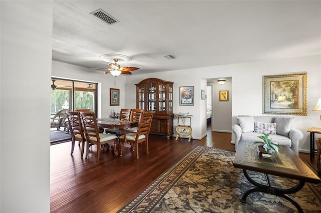 dining room featuring a ceiling fan, dark wood-type flooring, and baseboards