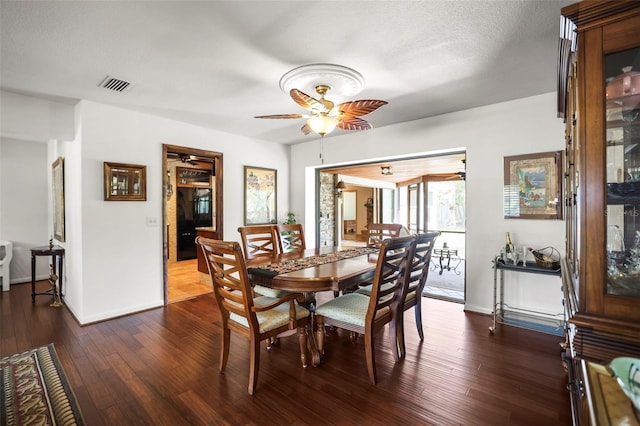 dining area featuring ceiling fan, dark wood-type flooring, and baseboards