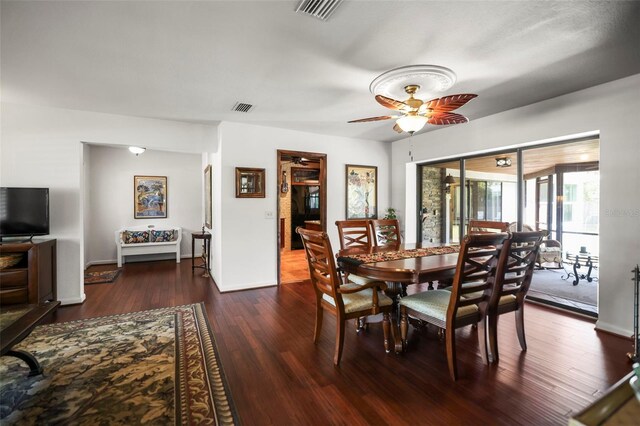 dining space with ceiling fan, wood finished floors, and baseboards