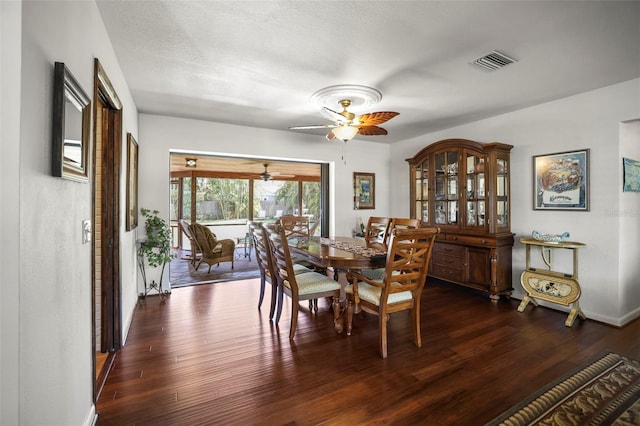 dining space with ceiling fan, dark wood-style floors, and baseboards