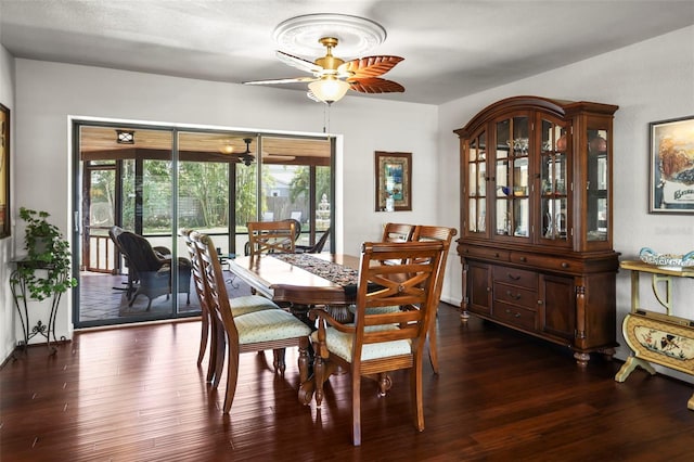 dining area featuring a ceiling fan, dark wood finished floors, and healthy amount of natural light
