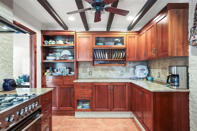 kitchen featuring beamed ceiling, decorative backsplash, open shelves, ceiling fan, and light stone countertops