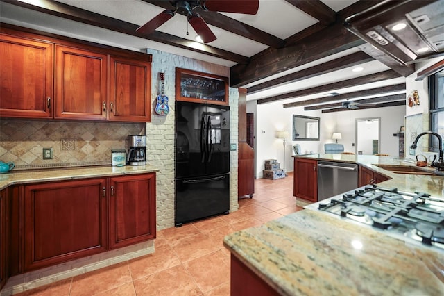 kitchen featuring freestanding refrigerator, dishwasher, a ceiling fan, a sink, and beamed ceiling