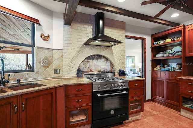 kitchen with range with gas cooktop, wall chimney exhaust hood, dark brown cabinets, a sink, and beam ceiling
