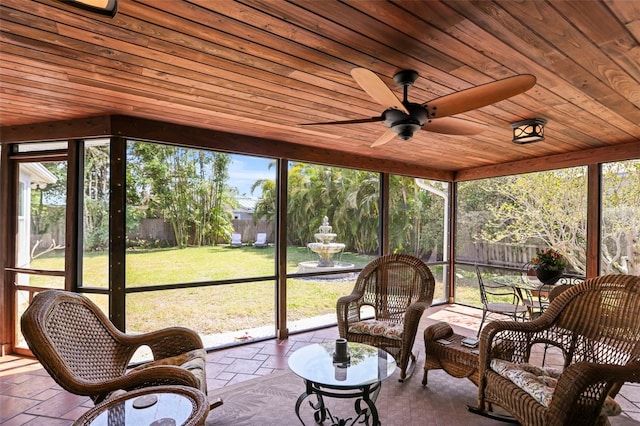 sunroom featuring ceiling fan and healthy amount of natural light
