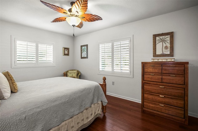 bedroom featuring dark wood-type flooring, multiple windows, baseboards, and ceiling fan