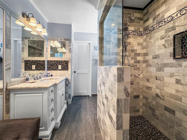 bathroom with crown molding, a walk in shower, vanity, and wood finished floors