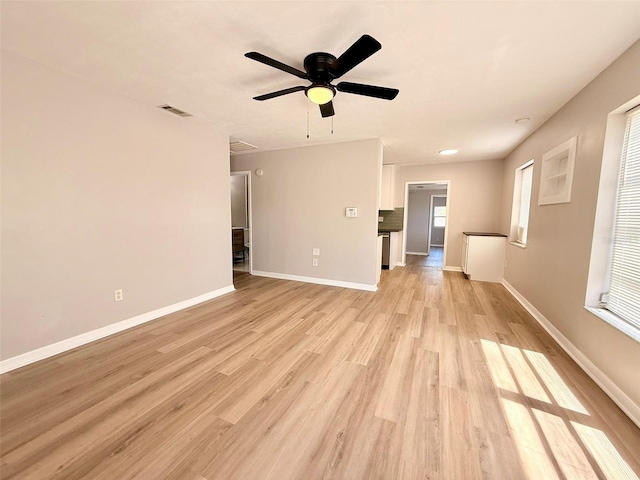 2201 Flamingo Ave, Deltona, FL 32738 - unfurnished living room featuring baseboards, light wood-style flooring, and a ceiling fan