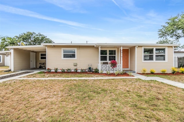 6816 13th St N, Saint Petersburg, FL 33702 - view of front facade featuring a front lawn, covered porch, driveway, and an attached carport