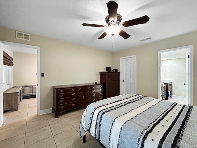 bedroom featuring light tile patterned floors, visible vents, baseboards, and ceiling fan