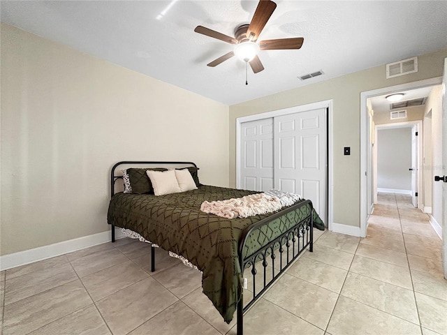bedroom with light tile patterned flooring, a closet, and visible vents
