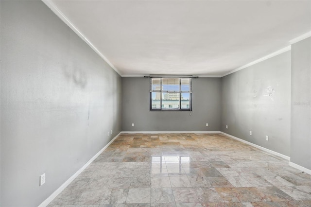 empty room featuring crown molding, baseboards, and marble finish floor