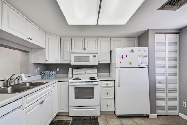 kitchen featuring a sink, white cabinetry, visible vents, white appliances, and light countertops
