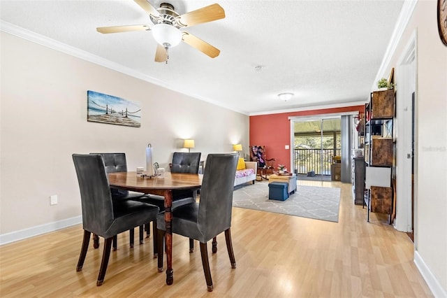 3823 N Oak Dr Unit K22, Tampa, FL 33611 - dining space with baseboards, light wood-style floors, crown molding, and a ceiling fan