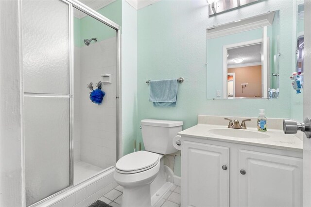 3823 N Oak Dr Unit K22, Tampa, FL 33611 - full bath with a stall shower, toilet, tile patterned flooring, vanity, and crown molding
