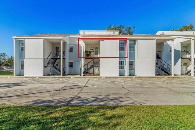 3823 N Oak Dr Unit K22, Tampa, FL 33611 - view of building exterior with stairs and uncovered parking