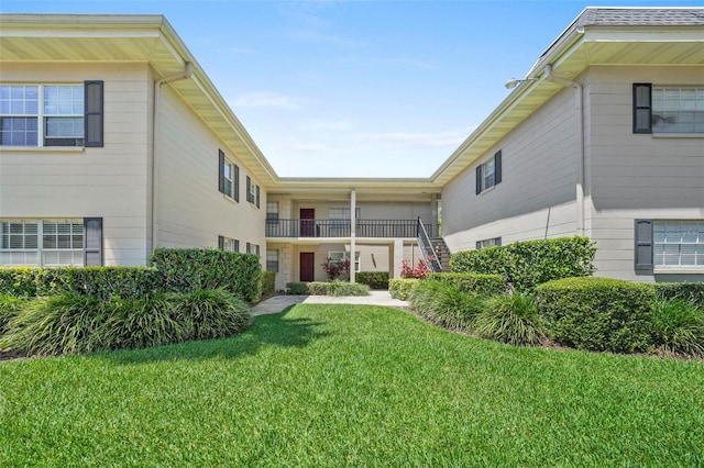 rear view of property featuring a yard