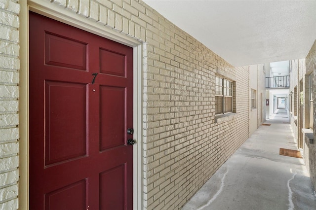 doorway to property with brick siding