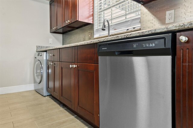 kitchen featuring dishwasher, washer / dryer, baseboards, and light stone countertops