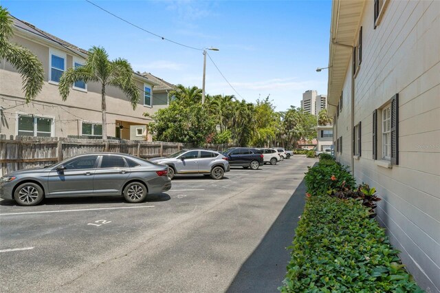 uncovered parking lot featuring fence