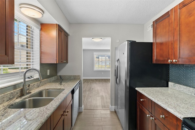 2207 S Carolina Ave Unit 7, Tampa, FL 33629 - kitchen with a sink, light wood-type flooring, appliances with stainless steel finishes, baseboards, and light stone counters