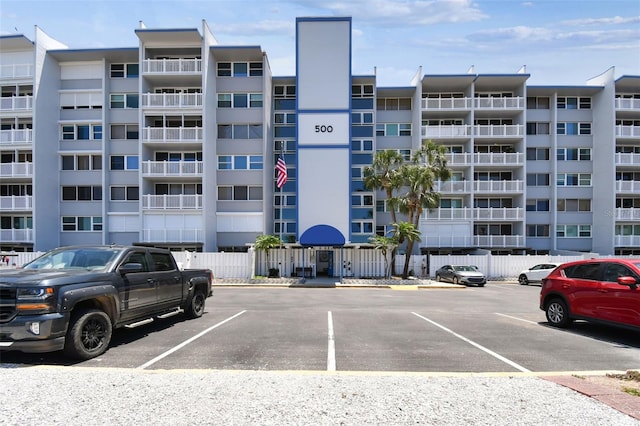 500 Treasure Island Cswy Unit 607, Treasure Island, FL 33706 - view of apartment building / complex featuring uncovered parking and fence