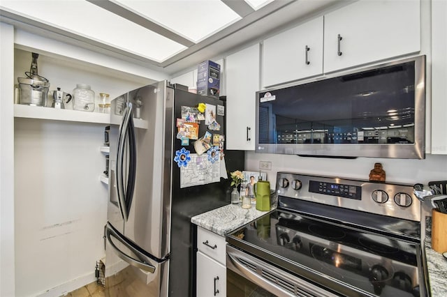 500 Treasure Island Cswy Unit 607, Treasure Island, FL 33706 - kitchen featuring appliances with stainless steel finishes and white cabinets