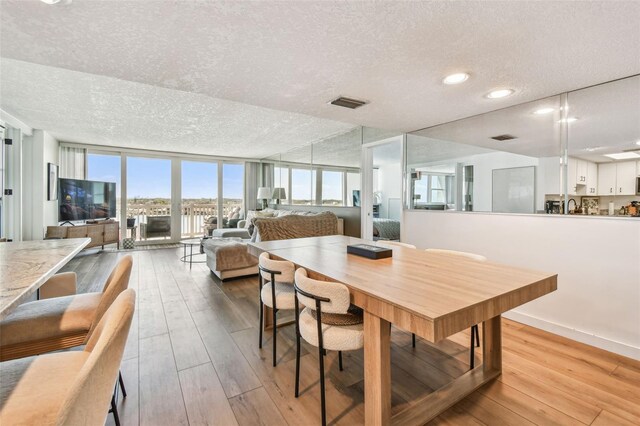 500 Treasure Island Cswy Unit 607, Treasure Island, FL 33706 - dining room with a textured ceiling, hardwood / wood-style floors, and recessed lighting