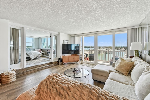 500 Treasure Island Cswy Unit 607, Treasure Island, FL 33706 - living area with hardwood / wood-style flooring and a textured ceiling